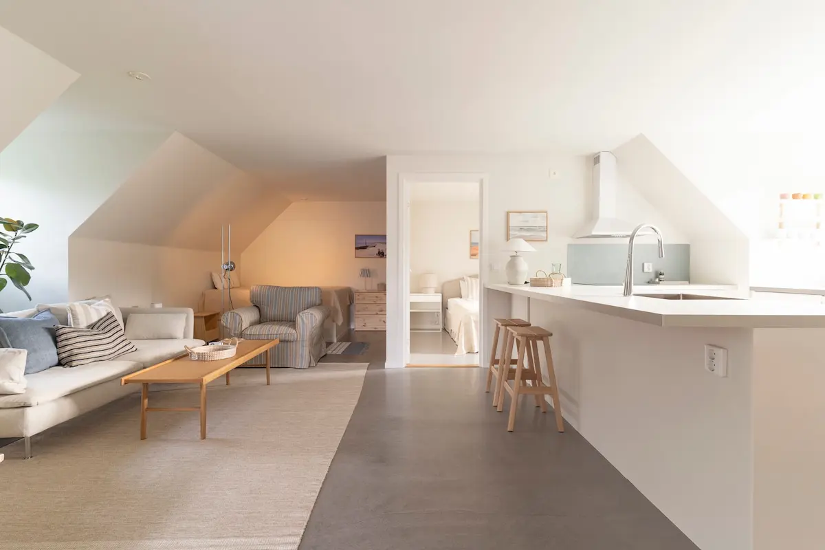 Open living room with sloped ceiling and natural light